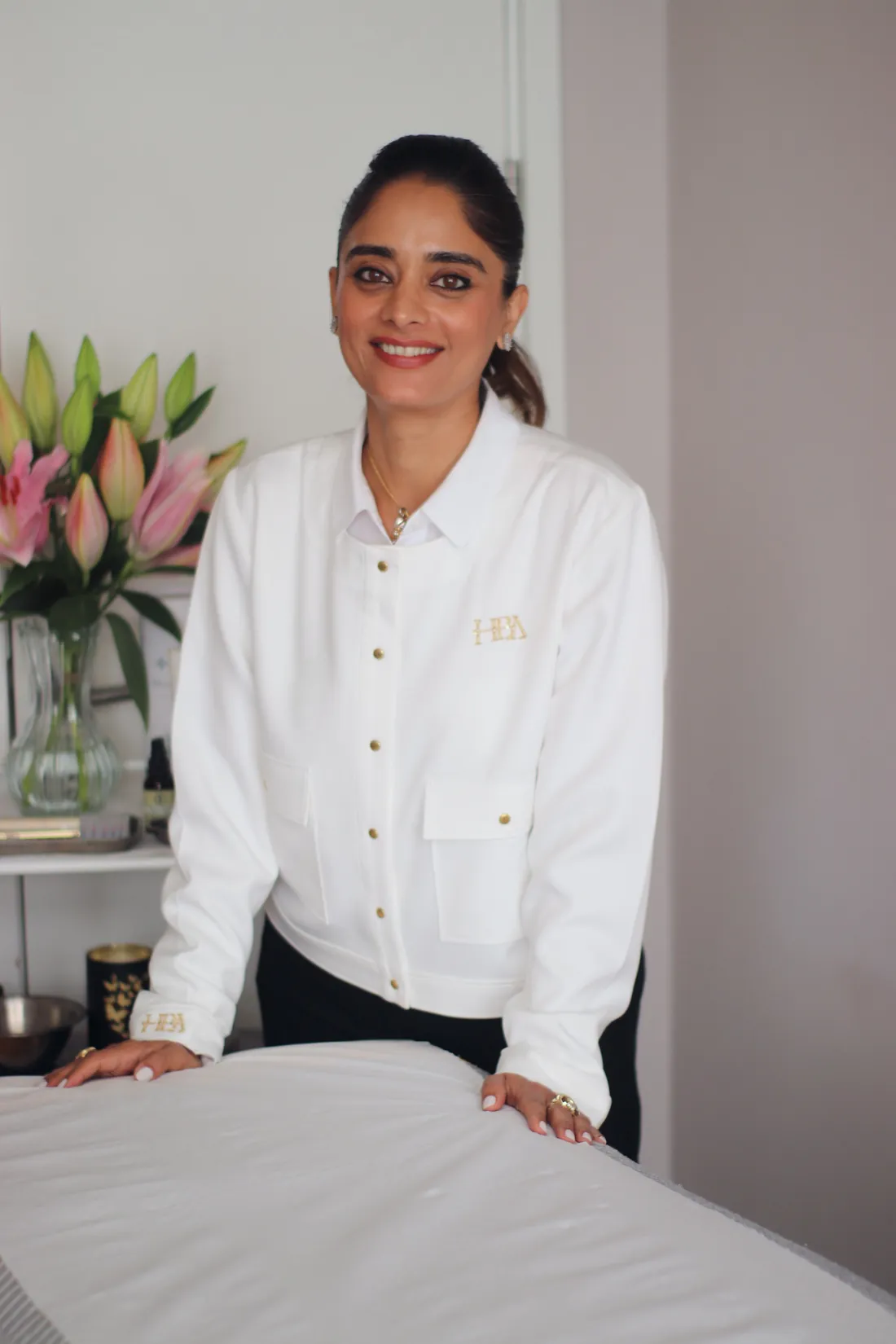 Pinky Lalwani, licensed acupuncturist, smiling in her London treatment room